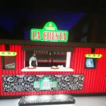 3D design of a La Casa food stand at night with a menu board and illuminated signage.